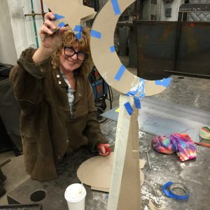 Welding moon and star on a tall pyramid - Janice at work on the "Two Brothers"